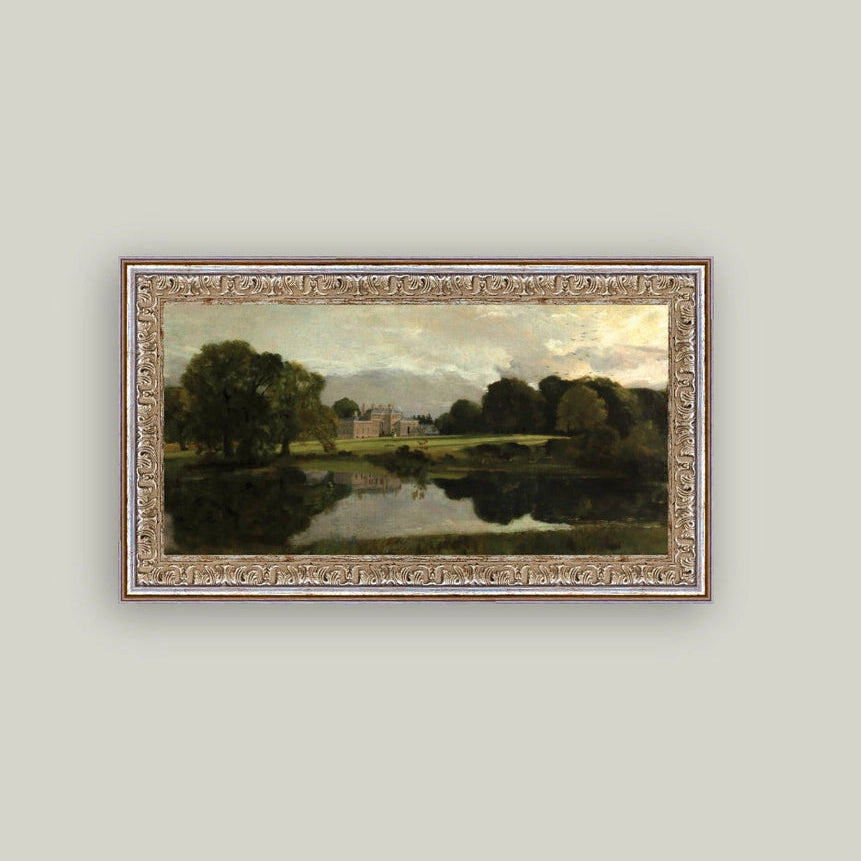 Framed landscape painting of a river scene on a light gray wall