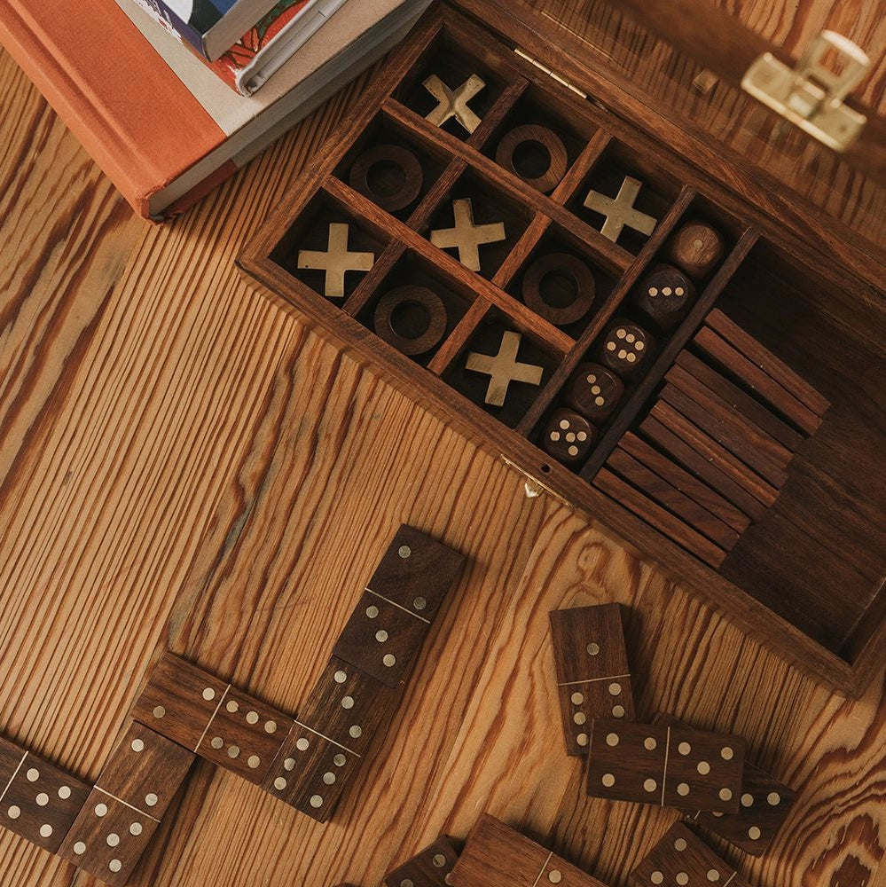 Wooden game set with dominoes and checkers on a wooden surface
