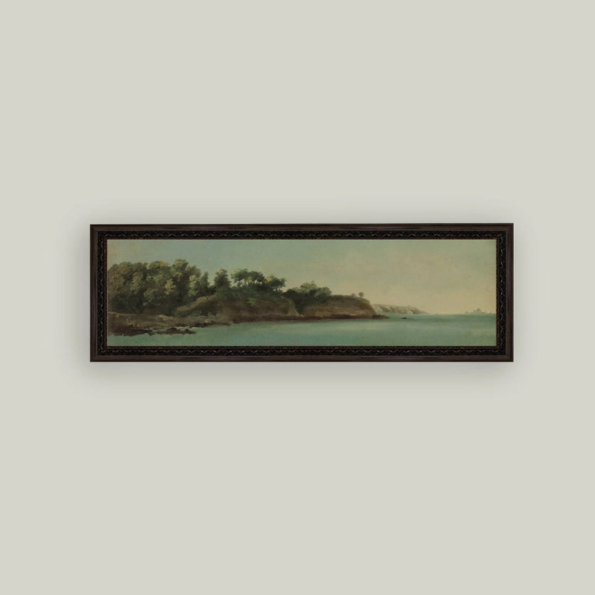 Framed artwork of a coastal scene with trees and water on a light gray wall.