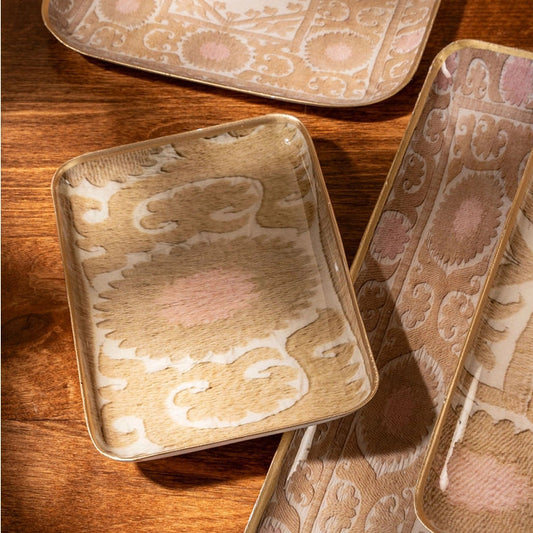 Set of decorative trays with a pattern on a wooden surface