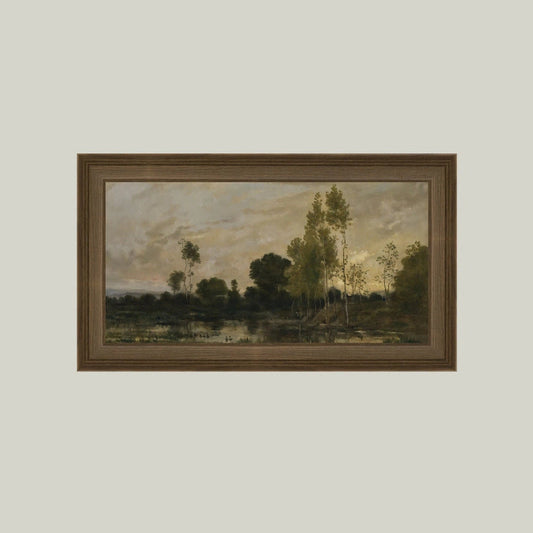 Framed painting of a landscape with trees and water on a plain wall.
