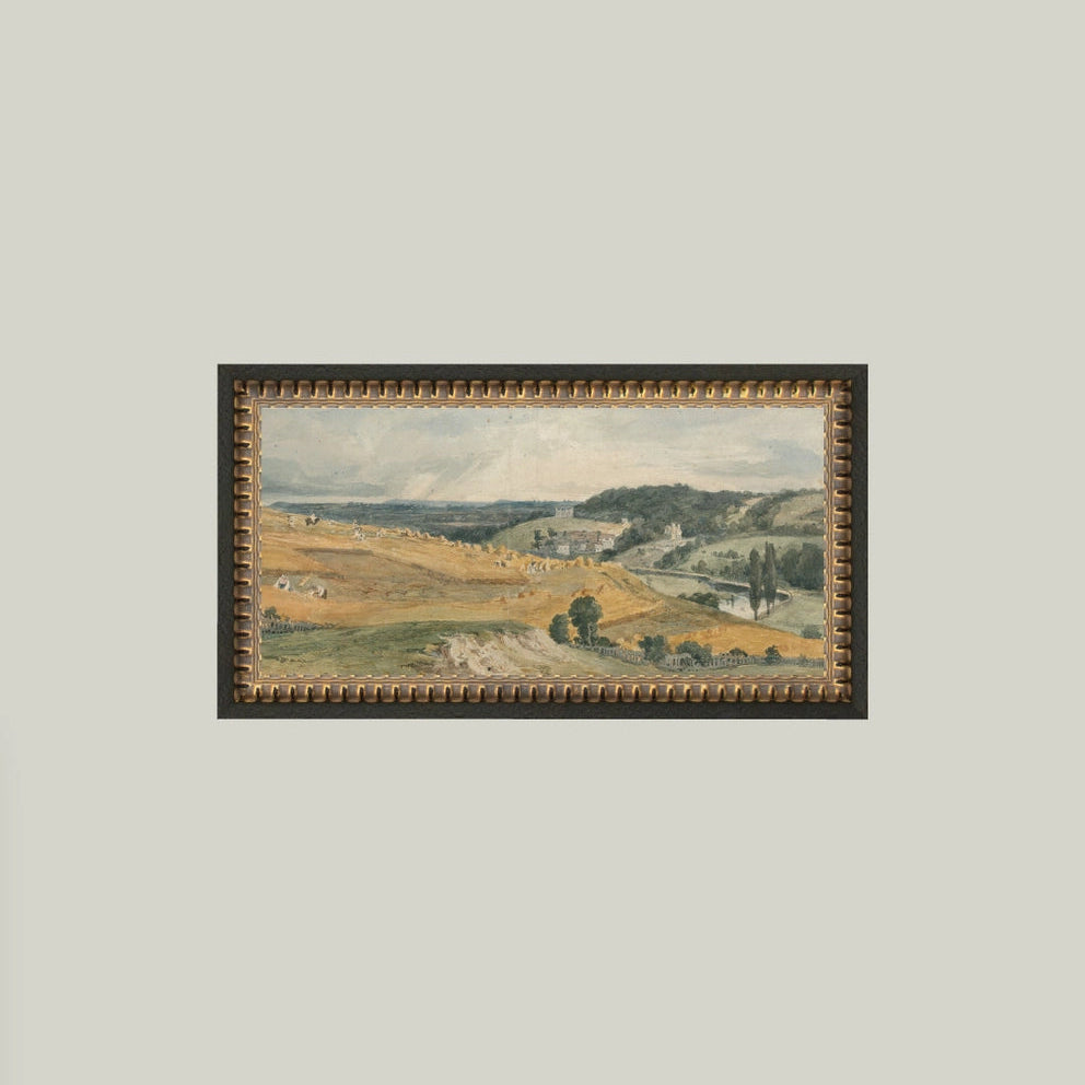 Framed landscape painting on a plain wall