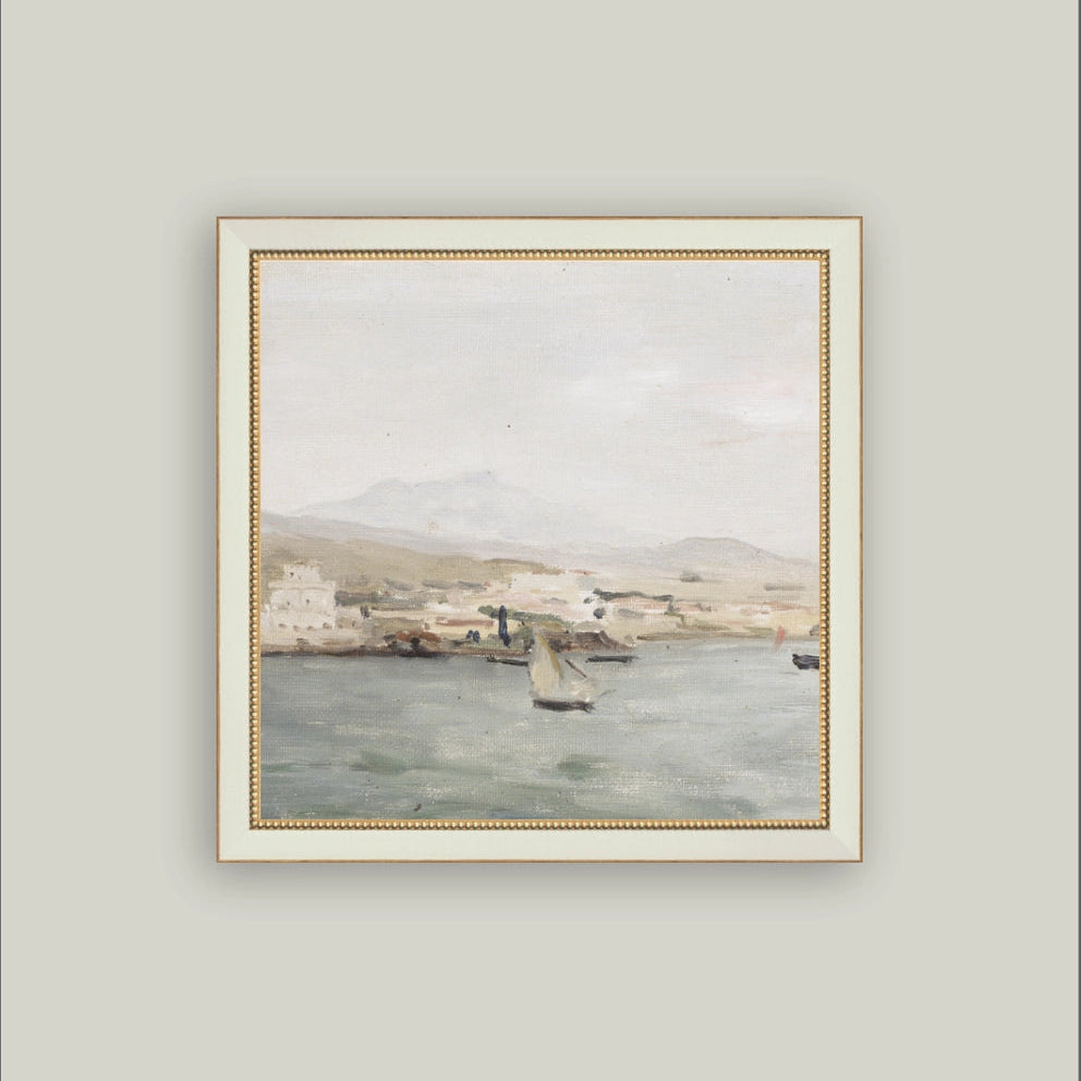 Framed painting of a coastal scene with boats on a gray wall